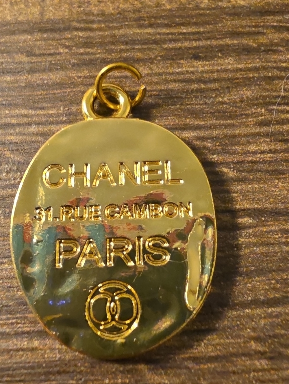 CHANEL Paris Gold Tone Oval Pendant Charm